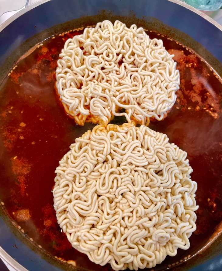 Ramen in skillet with sauce.
