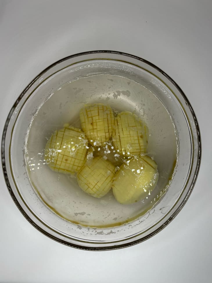 Potato pom poms in water before cooking.