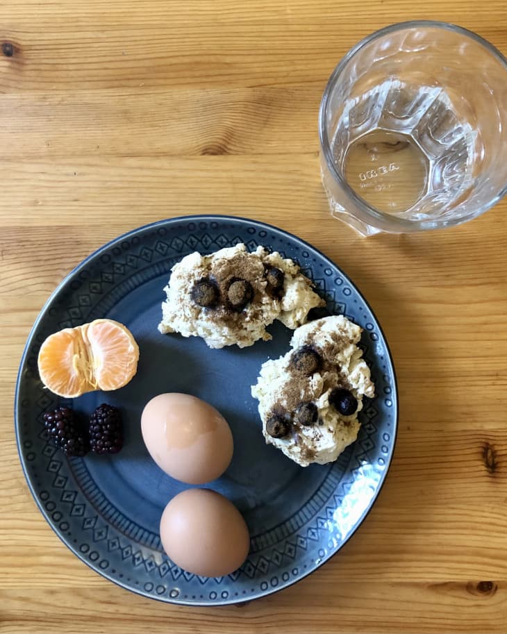 breakfast of eggs, fruit, biscuits on plate