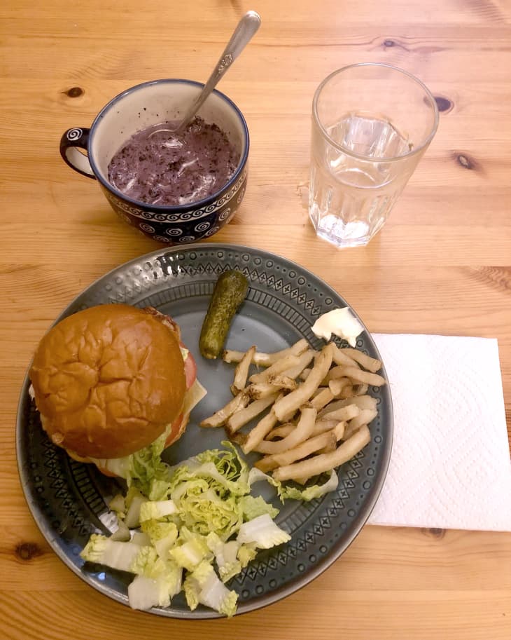 burger, fries, pickle, lettuce on plate