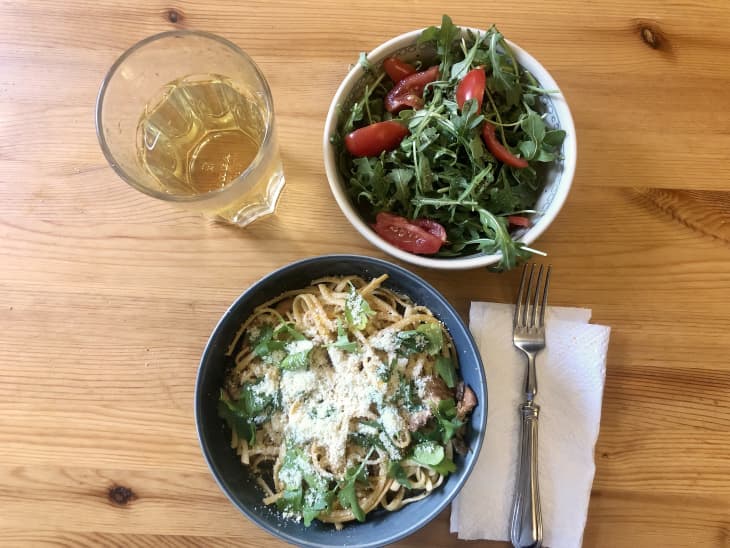 lunch of greens salad with tomatoes, and pasta dish with greens