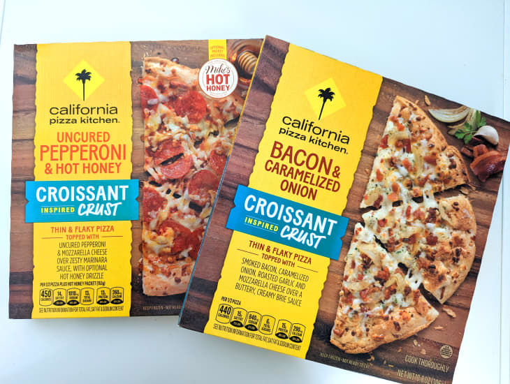 California Pizza Kitchen's Uncured pepperoni and hot honey and Bacon and Caramelized onion frozen pizzas in boxes.