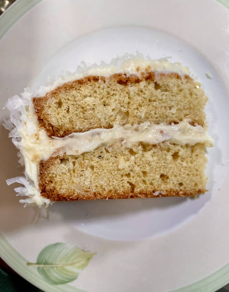 Slice of coconut cake on plate.