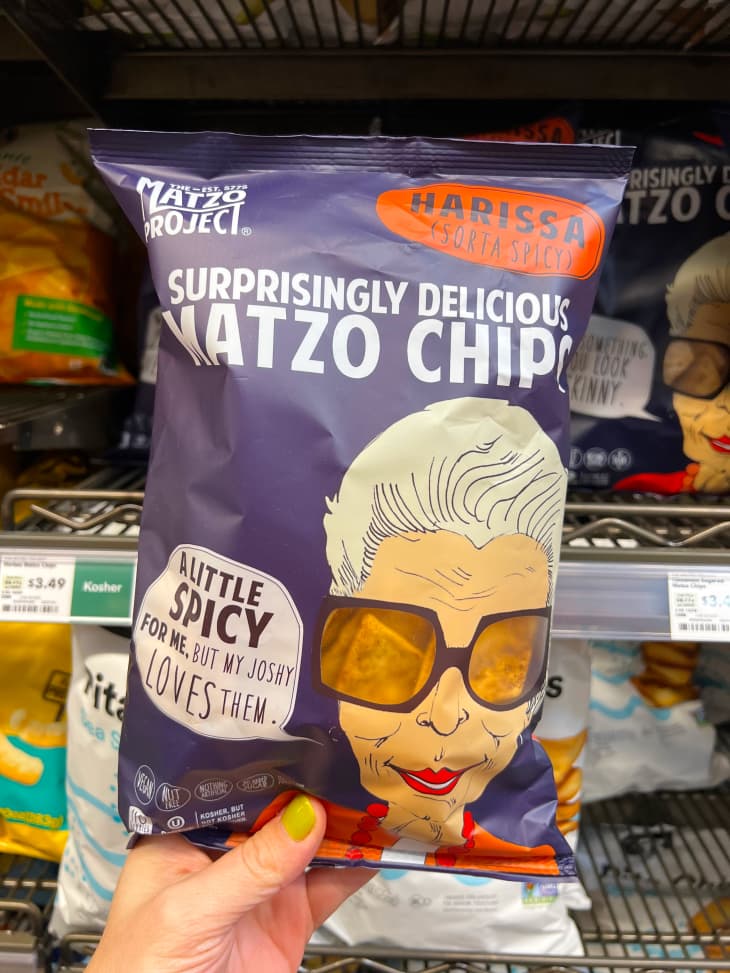 Someone holding a bag of Matzo Project's Matzo chips.