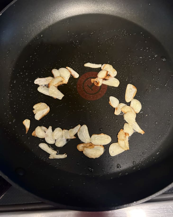 garlic cloves frying in pan