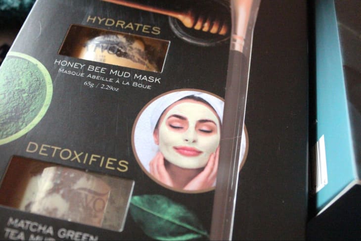 close-up of box with photo of woman wearing a face mask