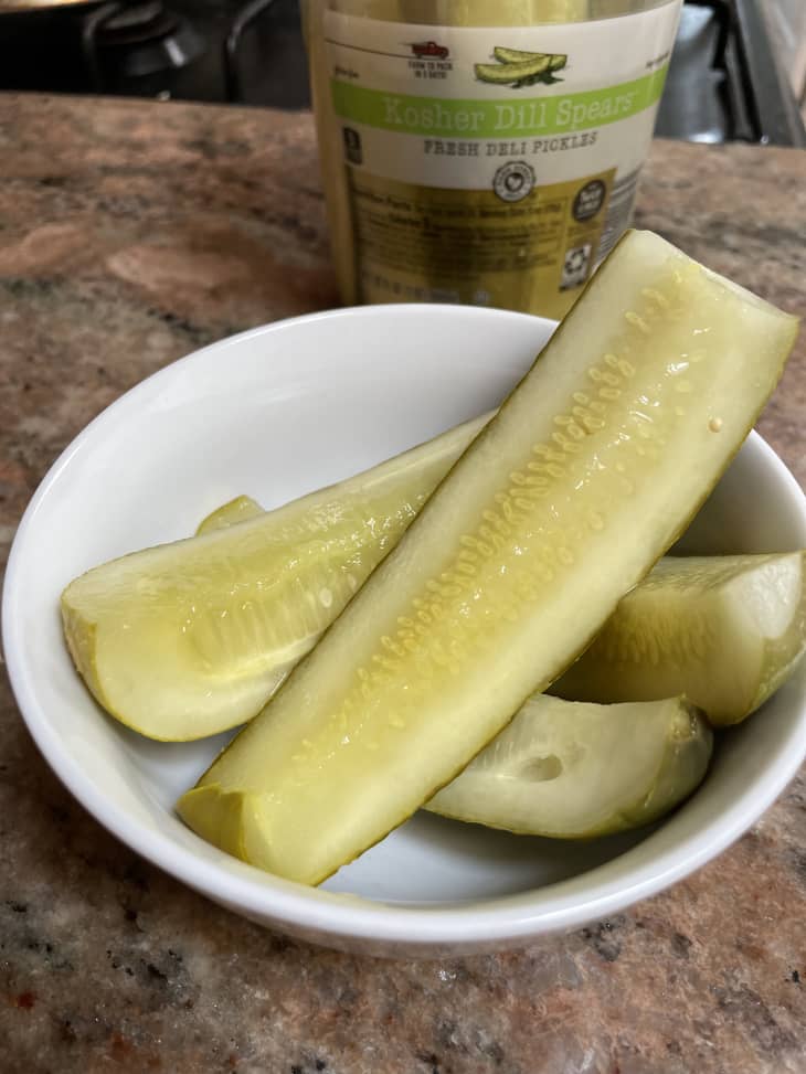 Sliced pickles on a white plate