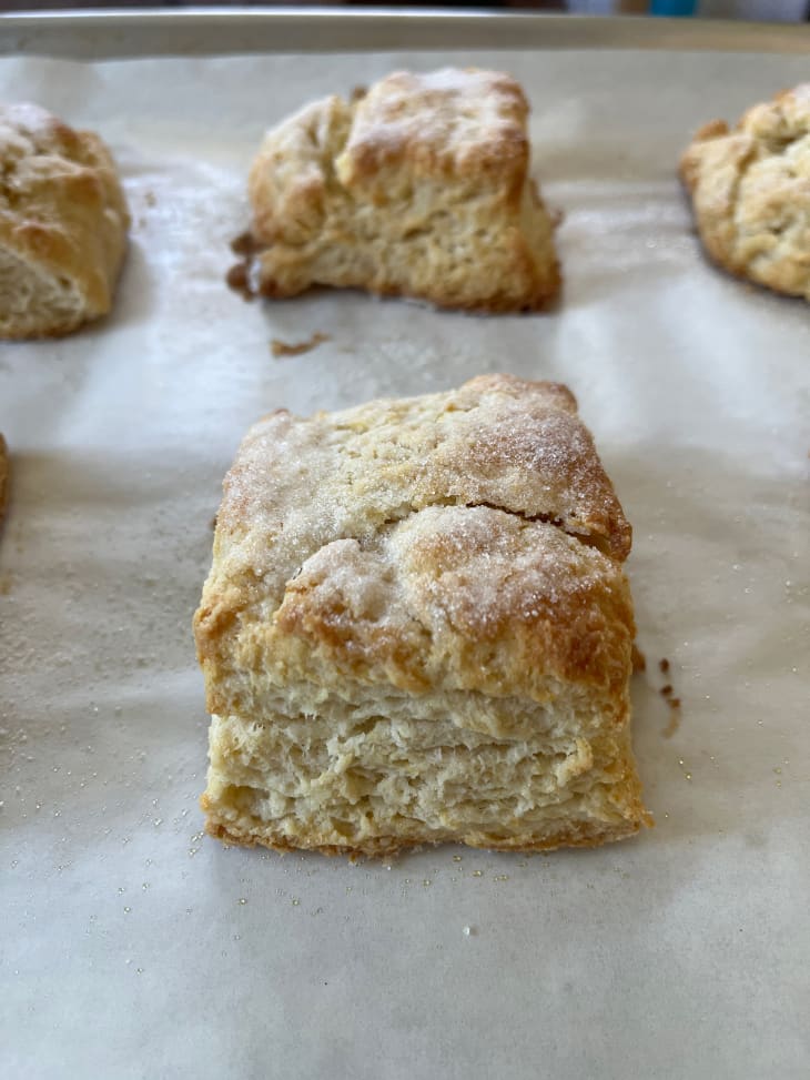 Freshly baked biscuits on baking sheet.