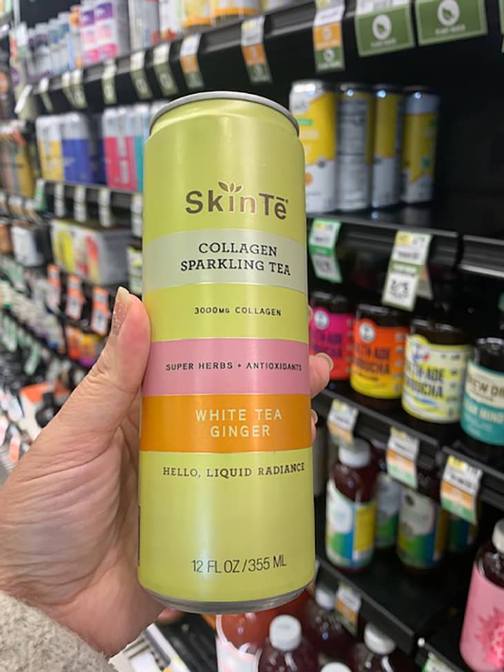 Someone holding up Skin Te collagen beverage in store.
