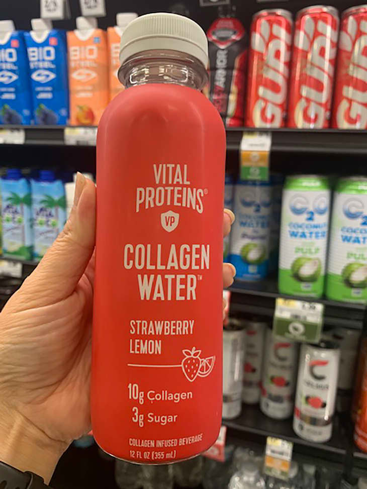 Someone holding up Vital Proteins collagen water in store.