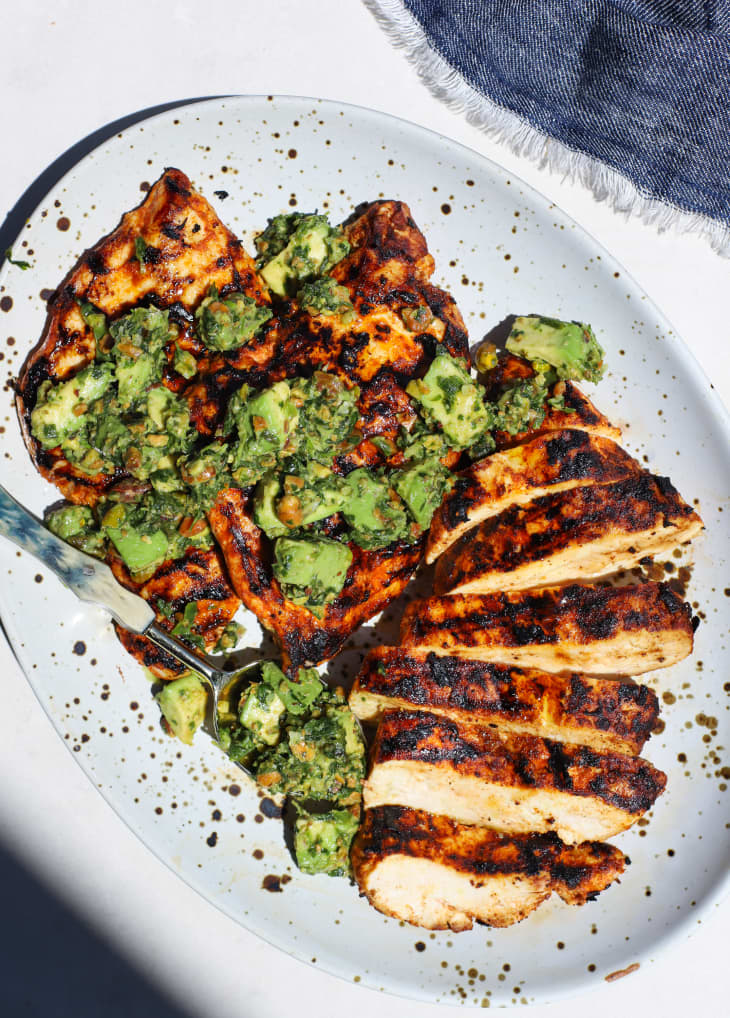 Grilled chicken with pistachio avocado relish drizzled on top.