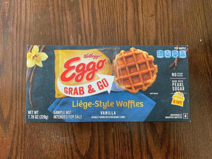 Eggo Liège-style waffles in package on wooden surface.