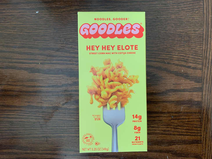 Goodles instant noodles on wooden surface.