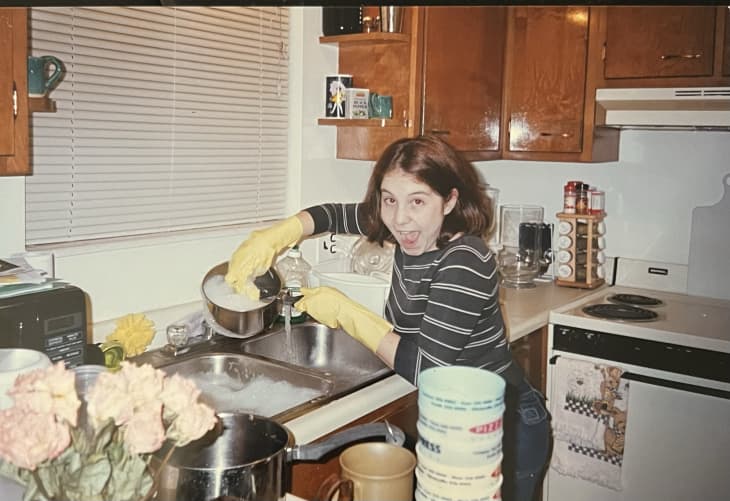 family photo of kid washing dishes in rubber gloves