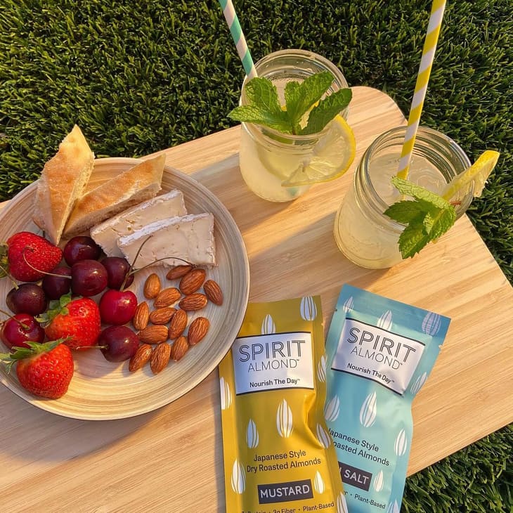 Picnic spread with one mustard and one sea salt flavor of Spirit almonds.
