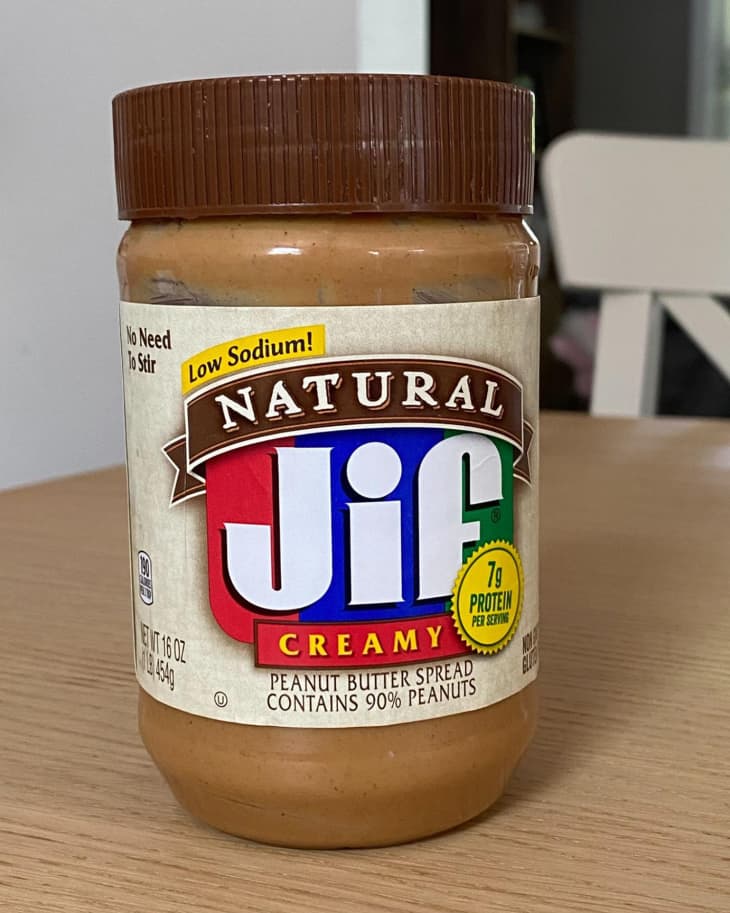 Jar of Natural Jif Creamy Peanut Butter on a table