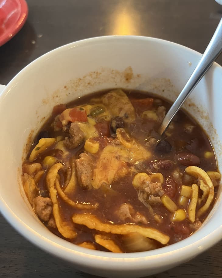 Turkey chili in bowl with grated cheddar cheese