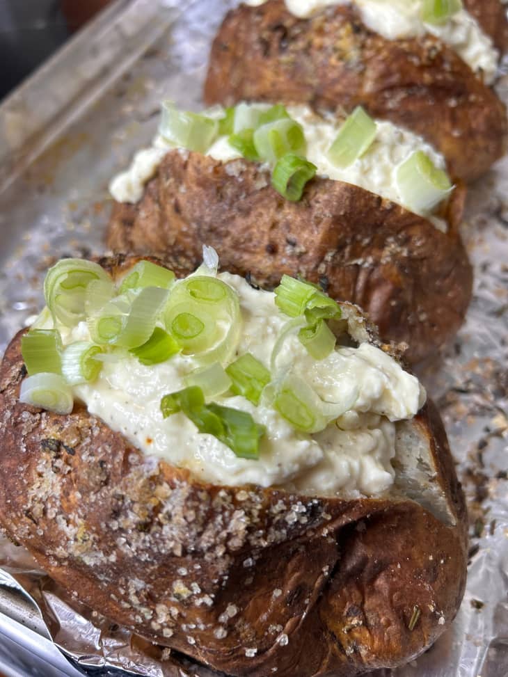 Crusty baked potatoes topped with whipped feta and scallions.