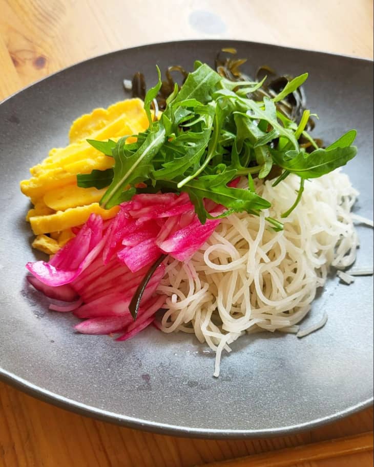 Plate with Tofu Shirataki Spaghetti topped with pickled onion, arugula