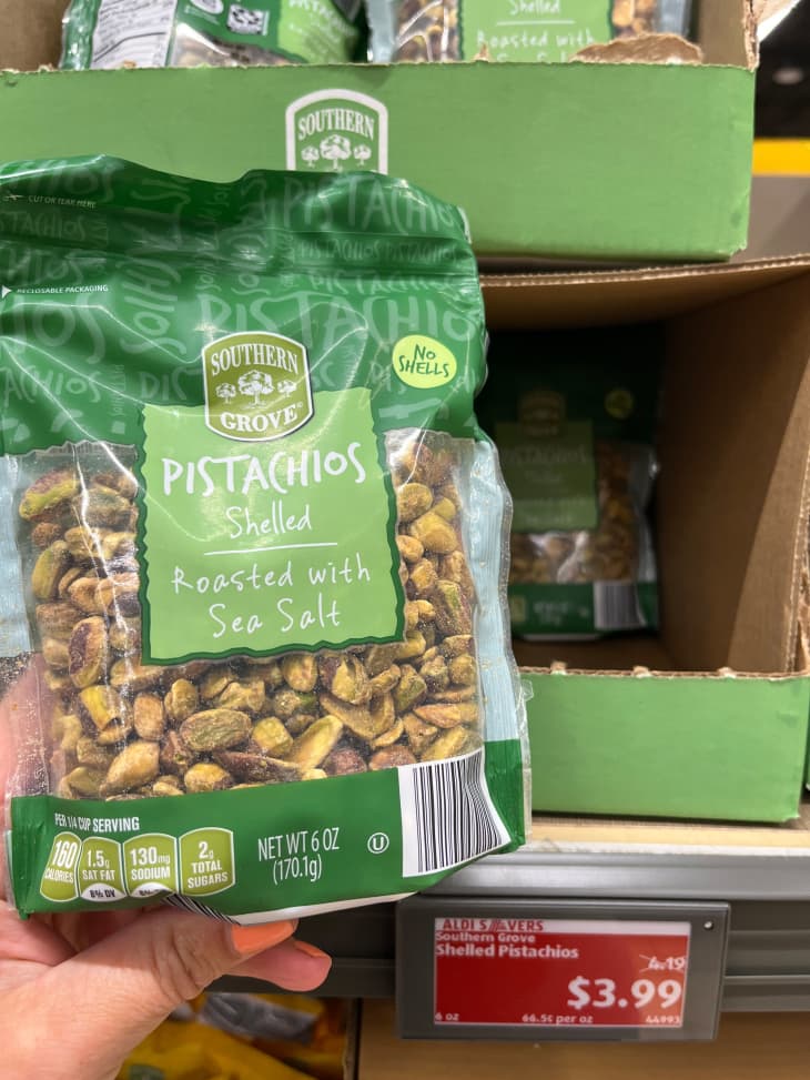 Someone holding package of shelled pistachio's in Aldi's