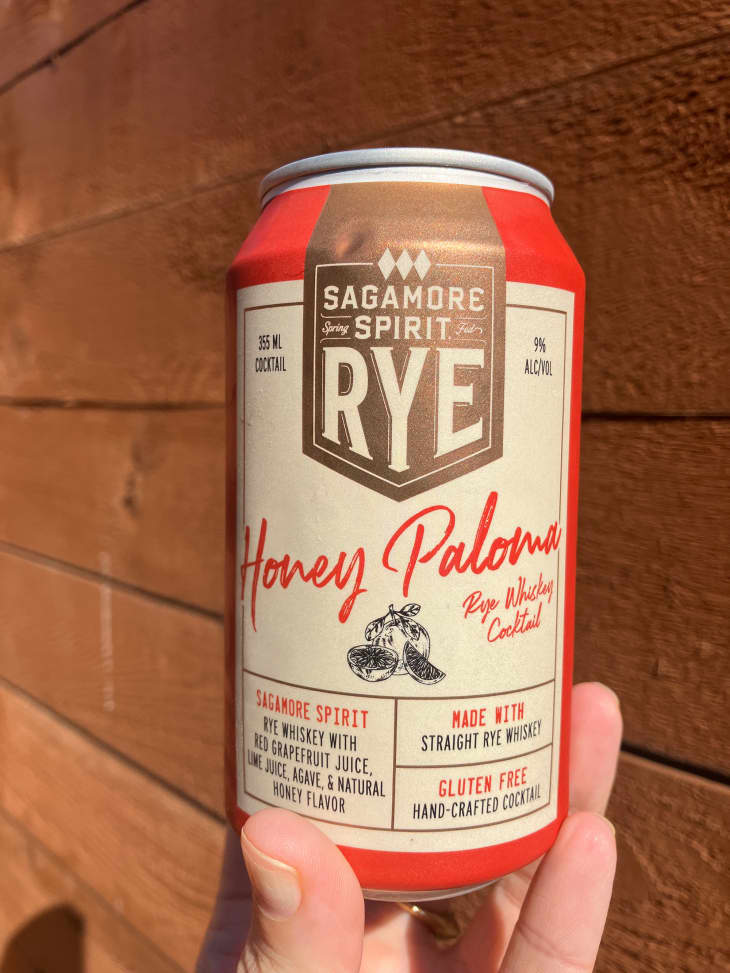 Someone holding can of Sagamore Spirit Rye Honey Paloma cocktail.