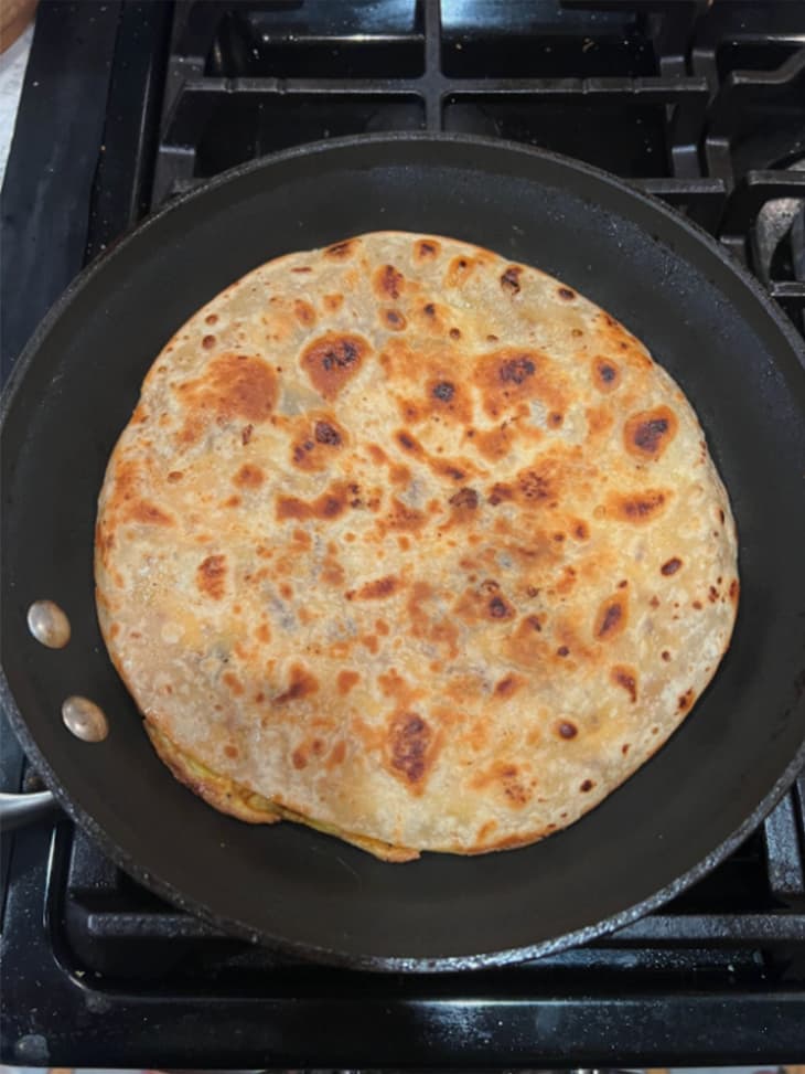 A cooked breakfast quesadilla in a black pan