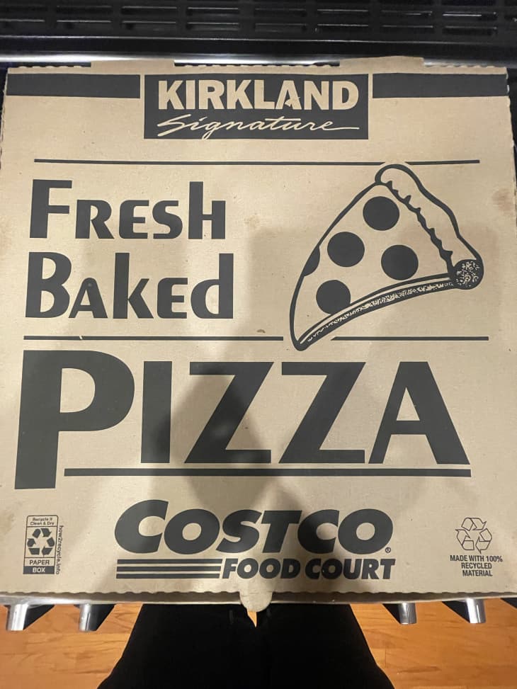 costco Kirkland pizza box sitting on a stovetop