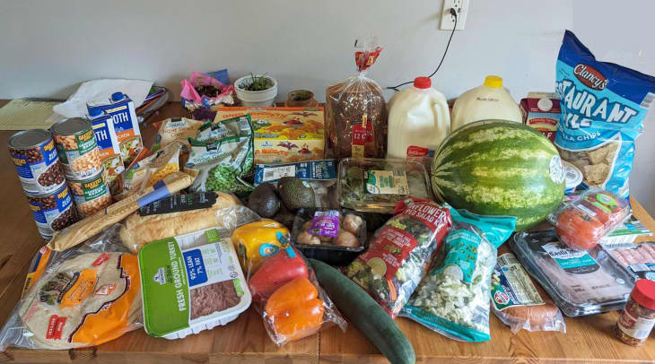 table full of groceries, grocery haul, fruit, dairy, chips, tortillas, vegetables, canned goods