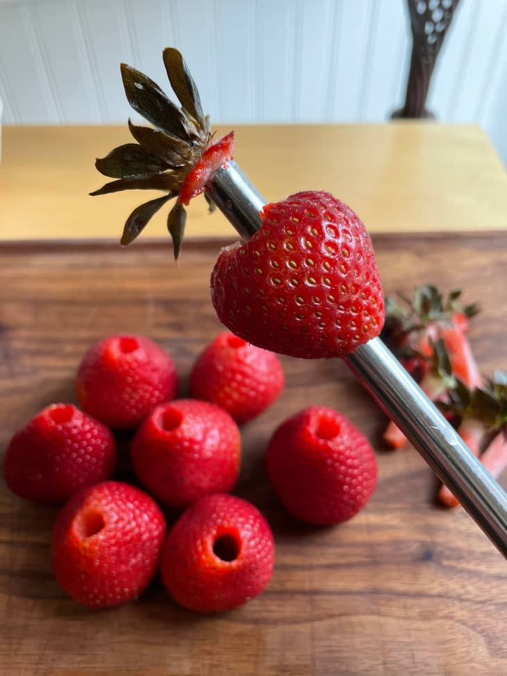 Strawberry being hulled on a reusable straw.