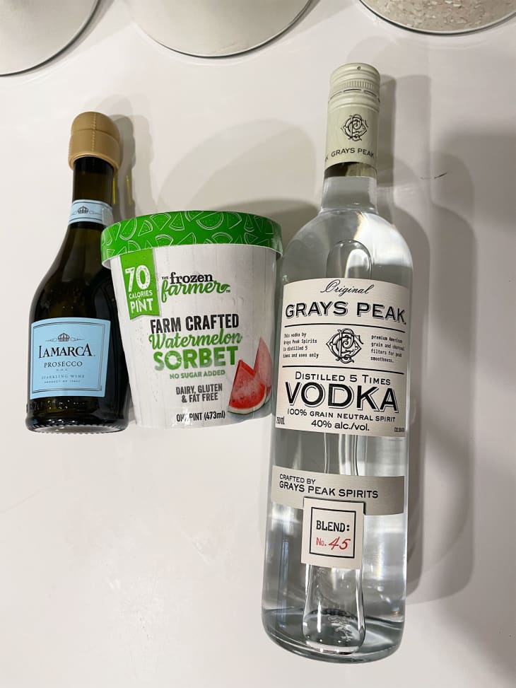 Ingredients on surface to make Sgroppino cocktail. Left to right: prosecco, sorbet, vodka.