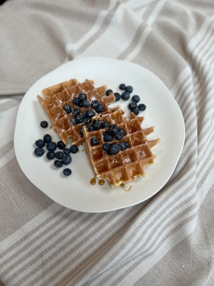 Belgian waffles topped with blueberries.