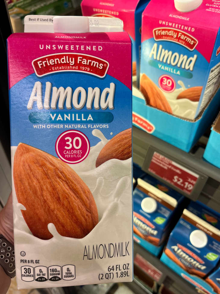 Someone holding carton on unsweetened almond milk.