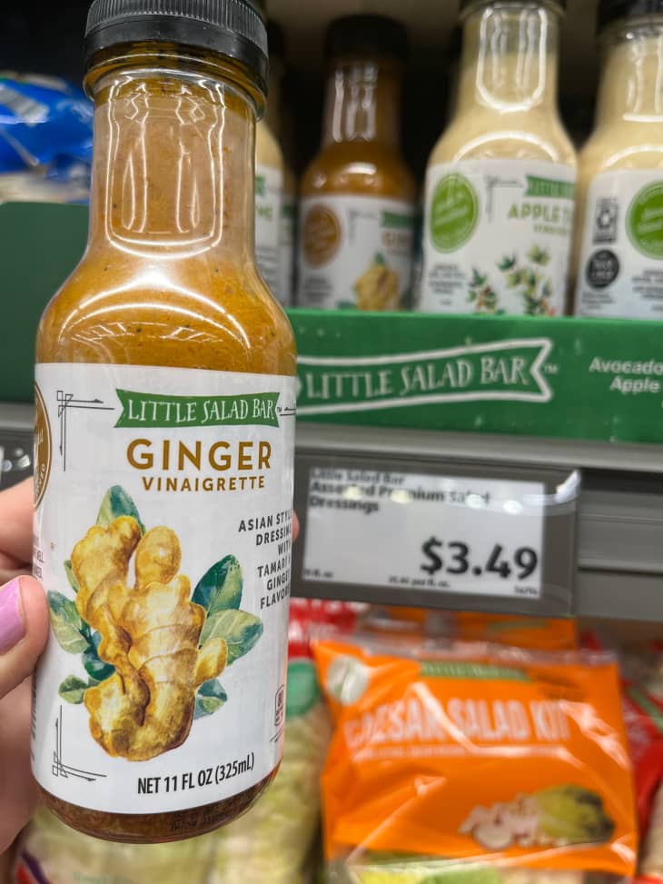 Someone holding bottle of ginger vinaigrette.