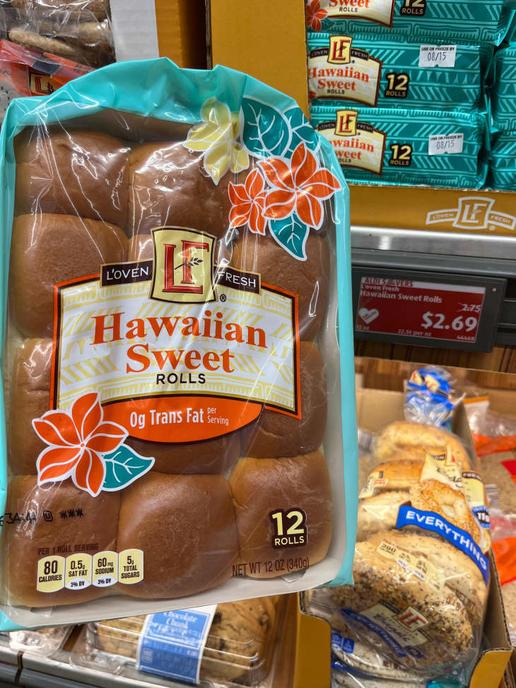 Someone holding package of Hawaiian Sweet rolls.