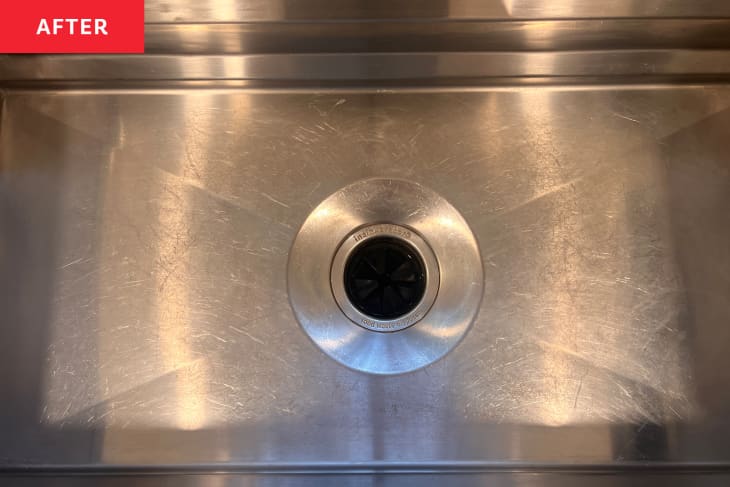 Cleaning stainless steel kitchen sink.