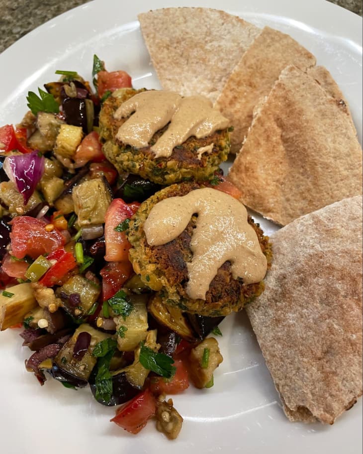 falafel with tahini sauce, pita wedges, and eggplant salad