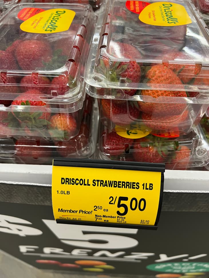 Packaged strawberries on grocery store shelf.