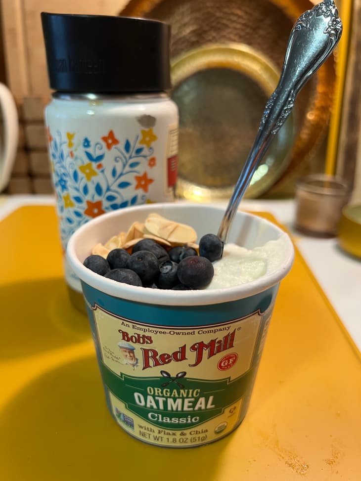 Bob's Red Mill oatmeal in carton topped with blueberries and almonds.