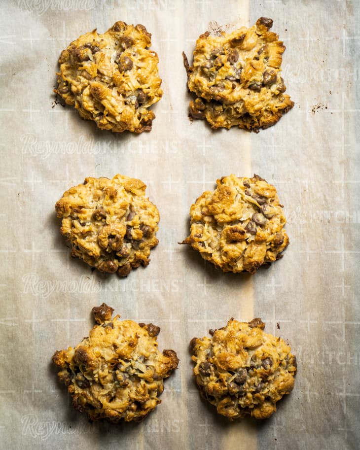 clumpy cookies on a sheet pan, parchment paper, chunky cookies with lots of oats and lumpy ingredients, chocolate chips