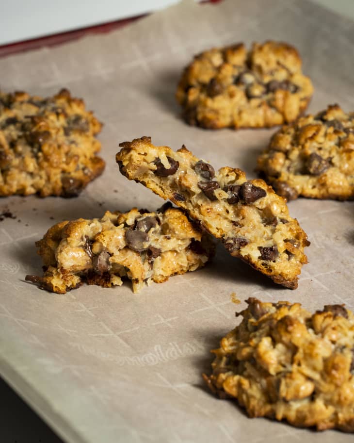 clumpy cookies on a sheet pan, parchment paper, chunky cookies with lots of oats and lumpy ingredients, chocolate chips