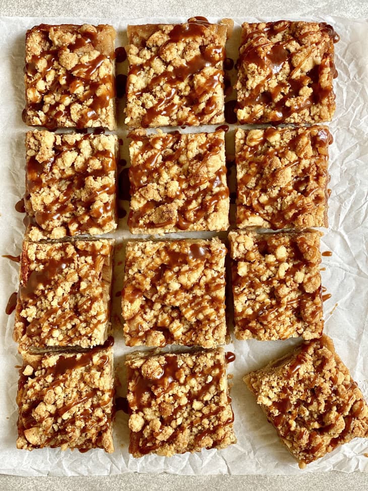 Cut up pieces of salted caramel-covered apple pie bars.