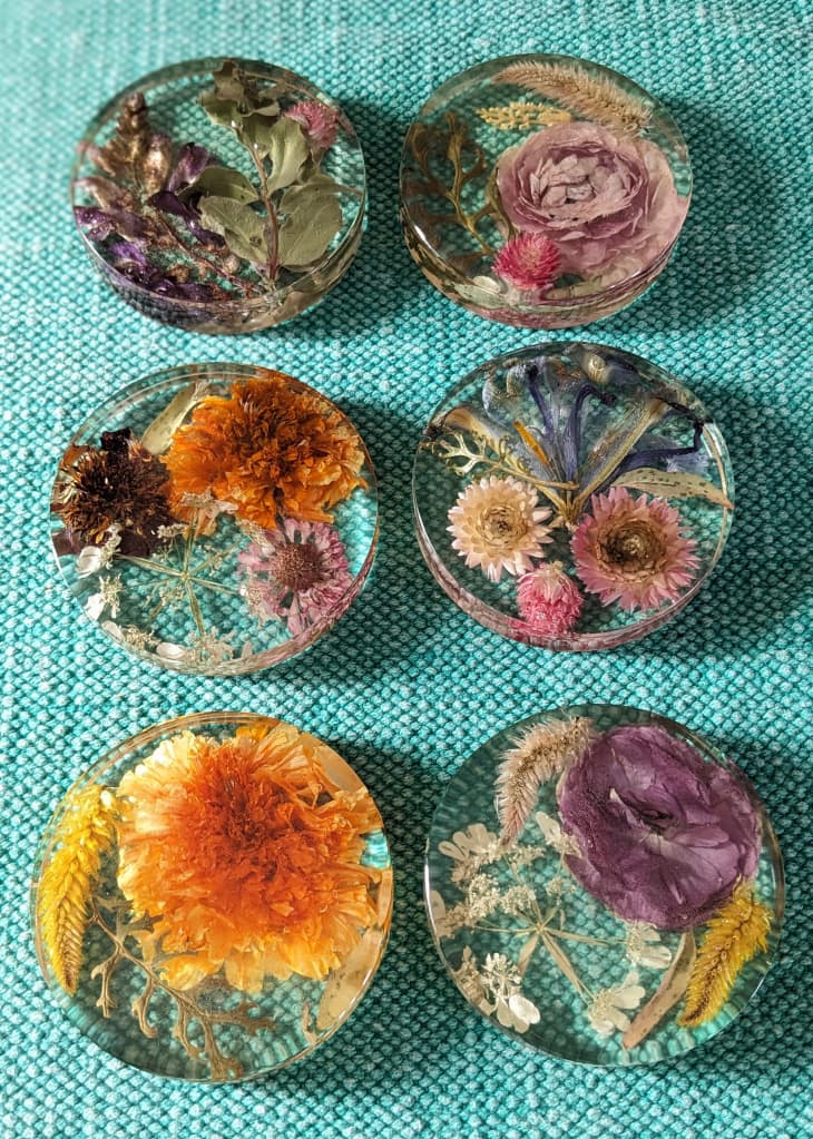 Six acrylic coaster with flowers embedded.