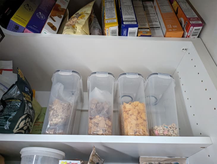 Kitchen pantry with various cereals stored in containers.