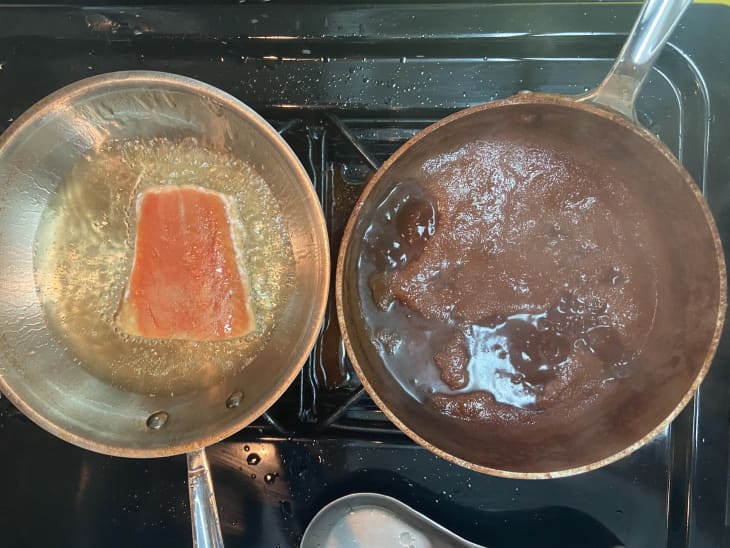 Cinnamon and salmon are fried on an oven in the kitchen.