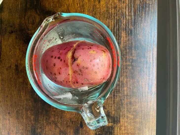 red potato soaking in measuring cup