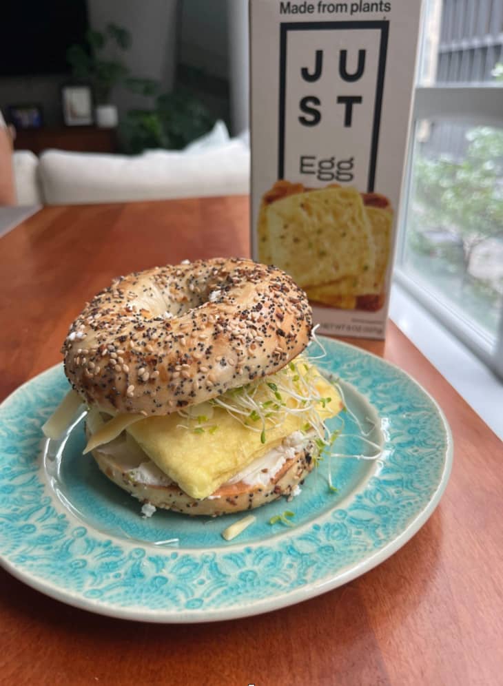 just egg folded egg patty on a bagel breakfast sandwich, turquoise plate, just egg prduct container in background