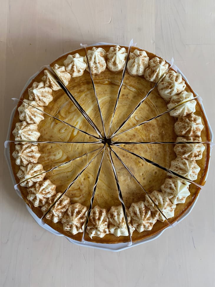 pumpkin cheesecake with paper between each slice