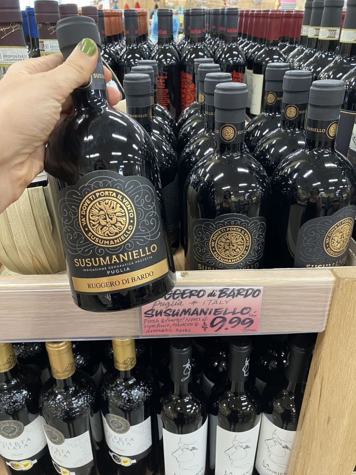 red wine bottles on shelf in trader joes