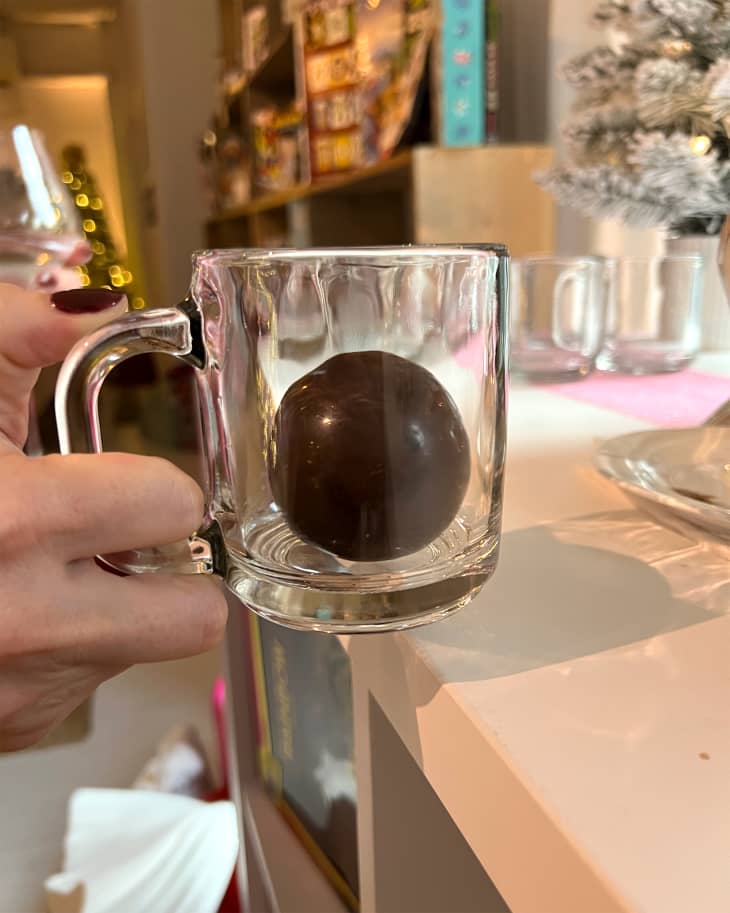 Chocolate bomb in glass mug.