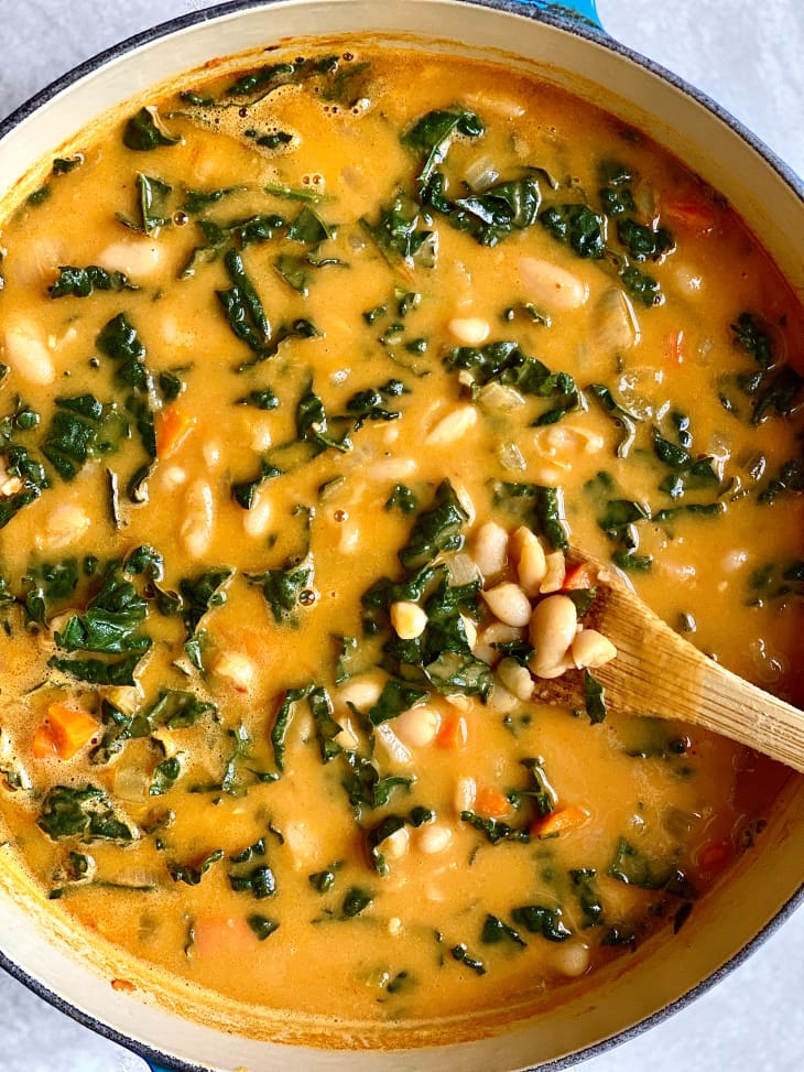 Creamy white bean and kale soup in Dutch oven.